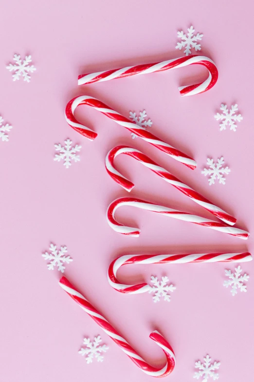 candy canes on a pink background with snowflakes, pexels, instagram picture, petite, thumbnail, made of glazed