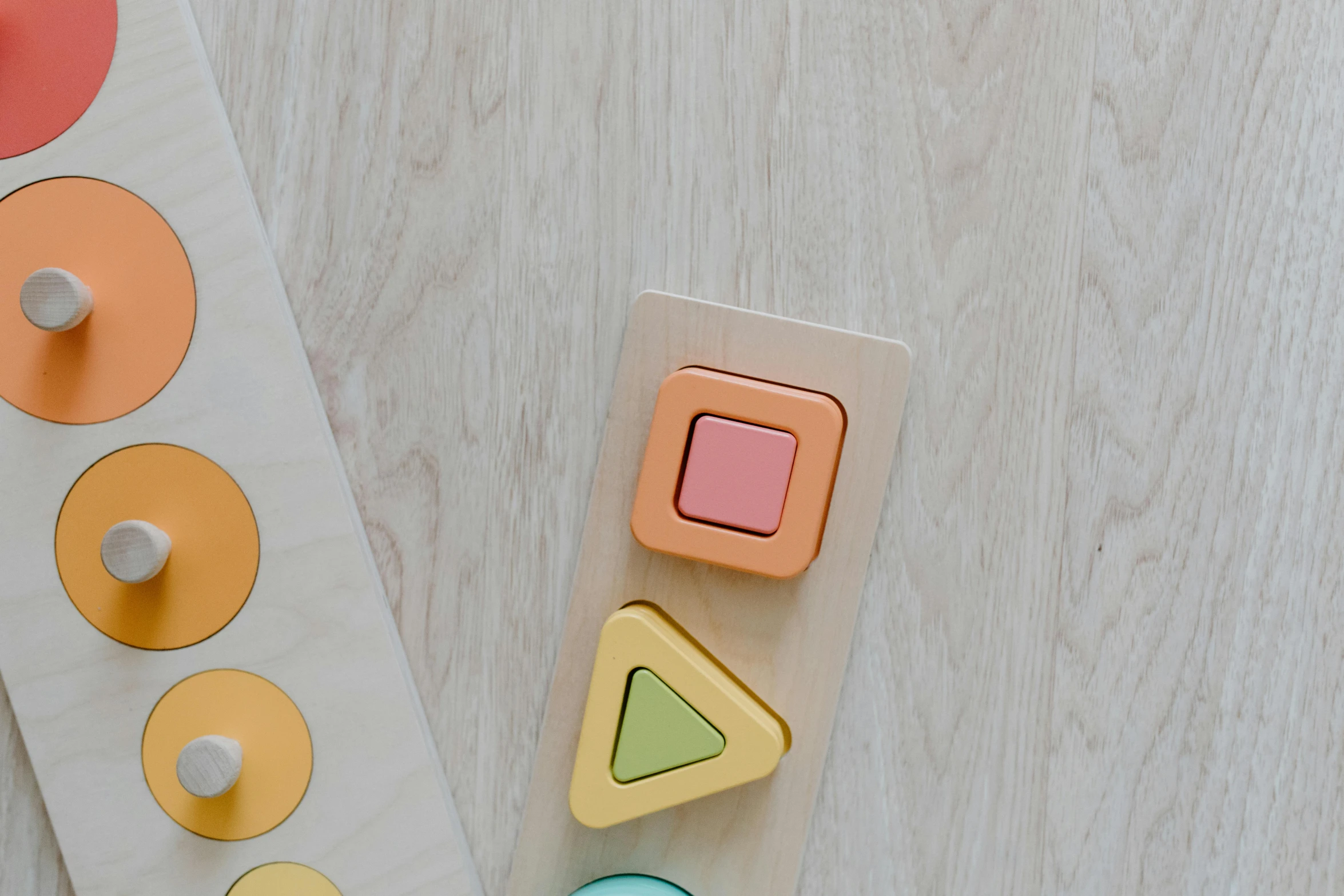 a close up of a wooden toy on a table, inspired by Frederick Hammersley, trending on pexels, pastel shades, buttons, threes, rectangle