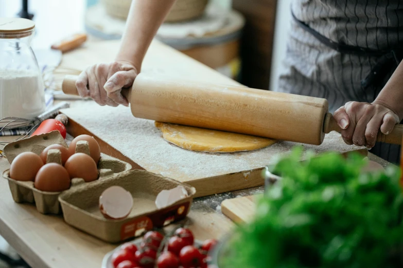 a person rolling out dough on a table, by Julia Pishtar, trending on pexels, fan favorite, herbs, tall, 15081959 21121991 01012000 4k