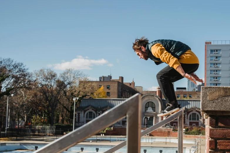 a man riding a skateboard down the side of a metal hand rail, trending on unsplash, figuration libre, in a jumping float pose, humans of new york, panoramic anamorphic, on a bright day