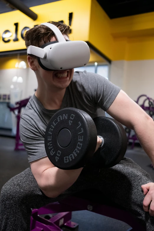 a man using a vr headset in a gym, reddit, in a planet fitness, big biceps, eyelevel perspective image, pulling the move'derp banshee '