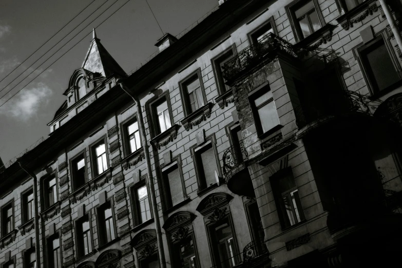 a black and white photo of a tall building, by andrei riabovitchev, pexels contest winner, baroque, soviet apartment buildings, location of a dark old house, late summer evening, square