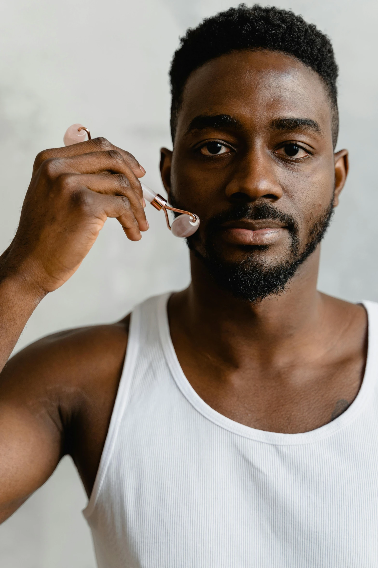 a man in a white tank top brushing his teeth, by Jessie Alexandra Dick, trending on pexels, renaissance, chocolate, a handsome man，black short hair, cereal, with a stethoscope