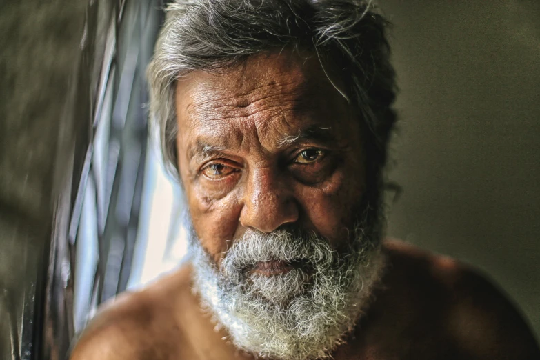 a close up of a man with a beard, pexels contest winner, hyperrealism, ranjit ghosh, grumpy [ old ], lovingly looking at camera, aboriginal