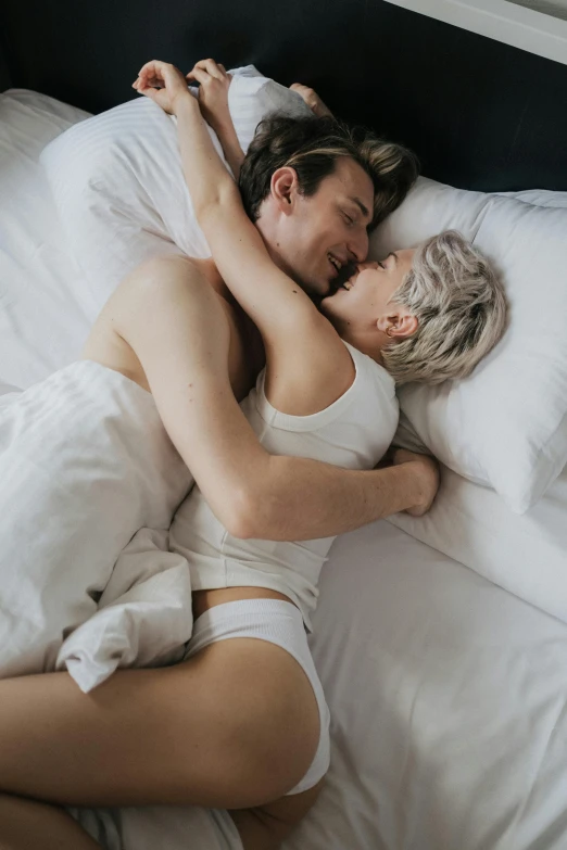 a man and woman laying in bed next to each other, lesbian embrace, sydney hanson, city morning, vine