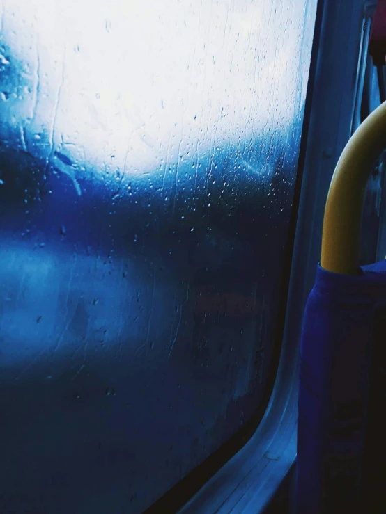 a close up of a handle on a bus, an album cover, unsplash, downpour, electric blue, rubber hose, low quality photo