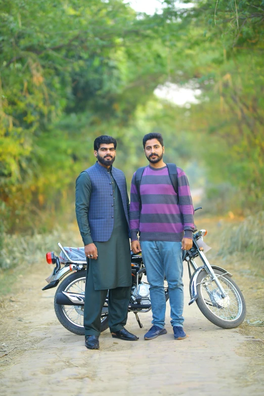 two men standing next to a motorcycle on a dirt road, a picture, by Riza Abbasi, autumn season, college students, without beard, 2 5 6 x 2 5 6 pixels