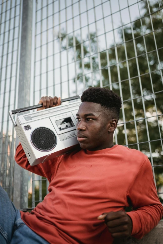 a man sitting on the ground with a boombox in his hand, by Barthélemy Menn, trending on pexels, black teenage boy, 15081959 21121991 01012000 4k, headshot, teddy fresh