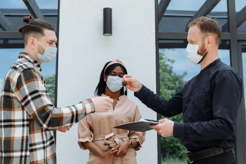 a man putting a face mask on a woman, pexels contest winner, people looking at a house, masked doctors, 3 heads, low quality photo