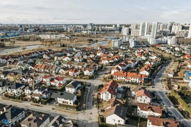 an aerial view of a city with lots of houses, by Emma Andijewska, pexels contest winner, hyperrealism, espoo, multiple wide angles, high quality photo, cinematic shot ar 9:16 -n 6 -g