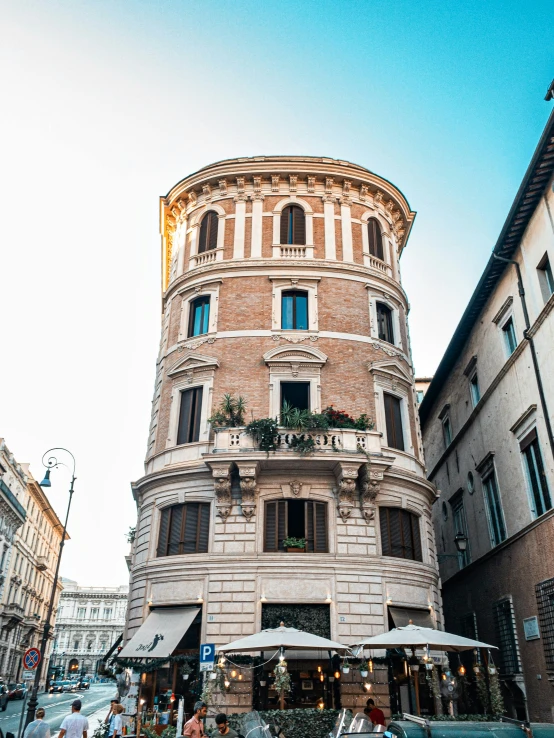 a tall building sitting on the side of a street, by Julia Pishtar, pexels contest winner, neoclassicism, former gasometer in rome, tavern, profile image, thick squares and large arrows