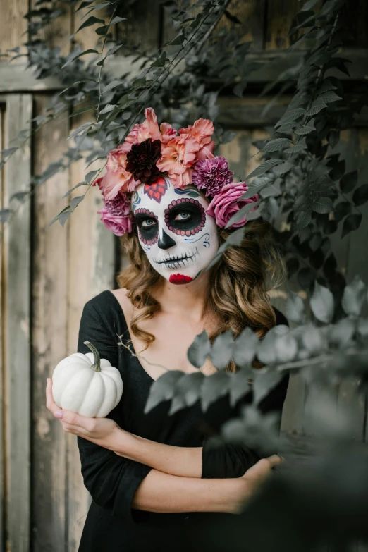 a woman in a day of the dead costume holding a pumpkin, pexels contest winner, renaissance, square, made of flowers and berries, black, made of leaf skeleton