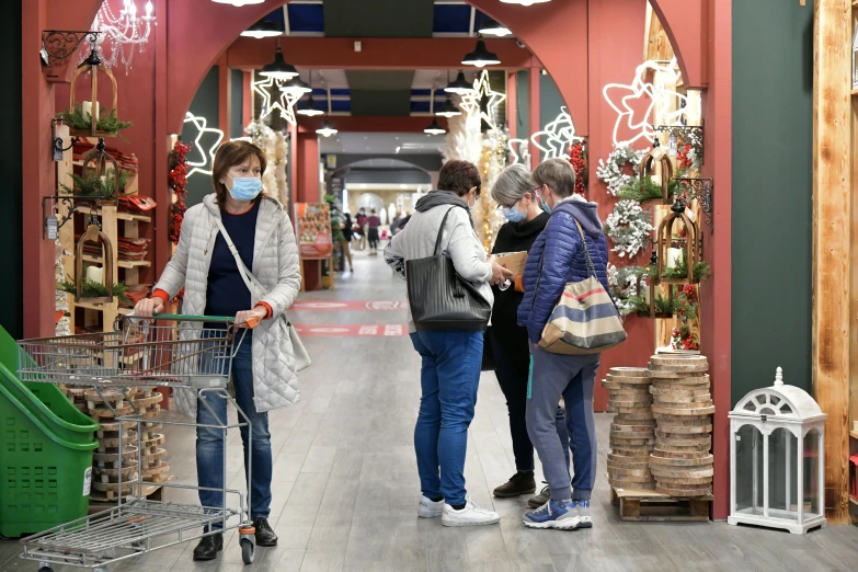 a group of people standing next to each other in a store, decorations, coronavirus, simone graci, marketplace