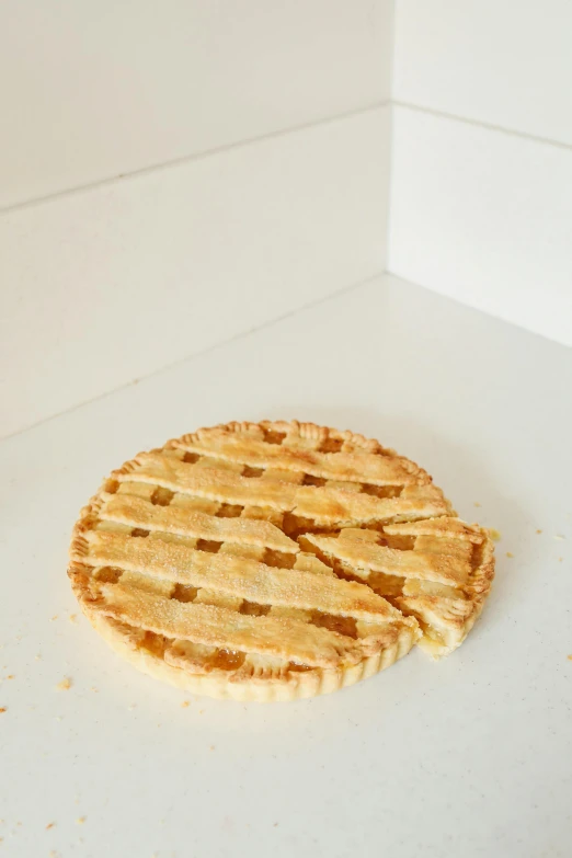 a pie sitting on top of a white counter, detailed product image, marmalade, ground level shot, very thin