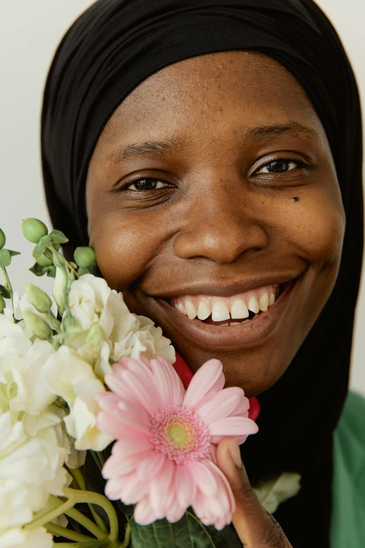 a woman smiles while holding a bouquet of flowers, by Ellen Gallagher, hurufiyya, african ameera al taweel, middle close up, riyahd cassiem, lily frank