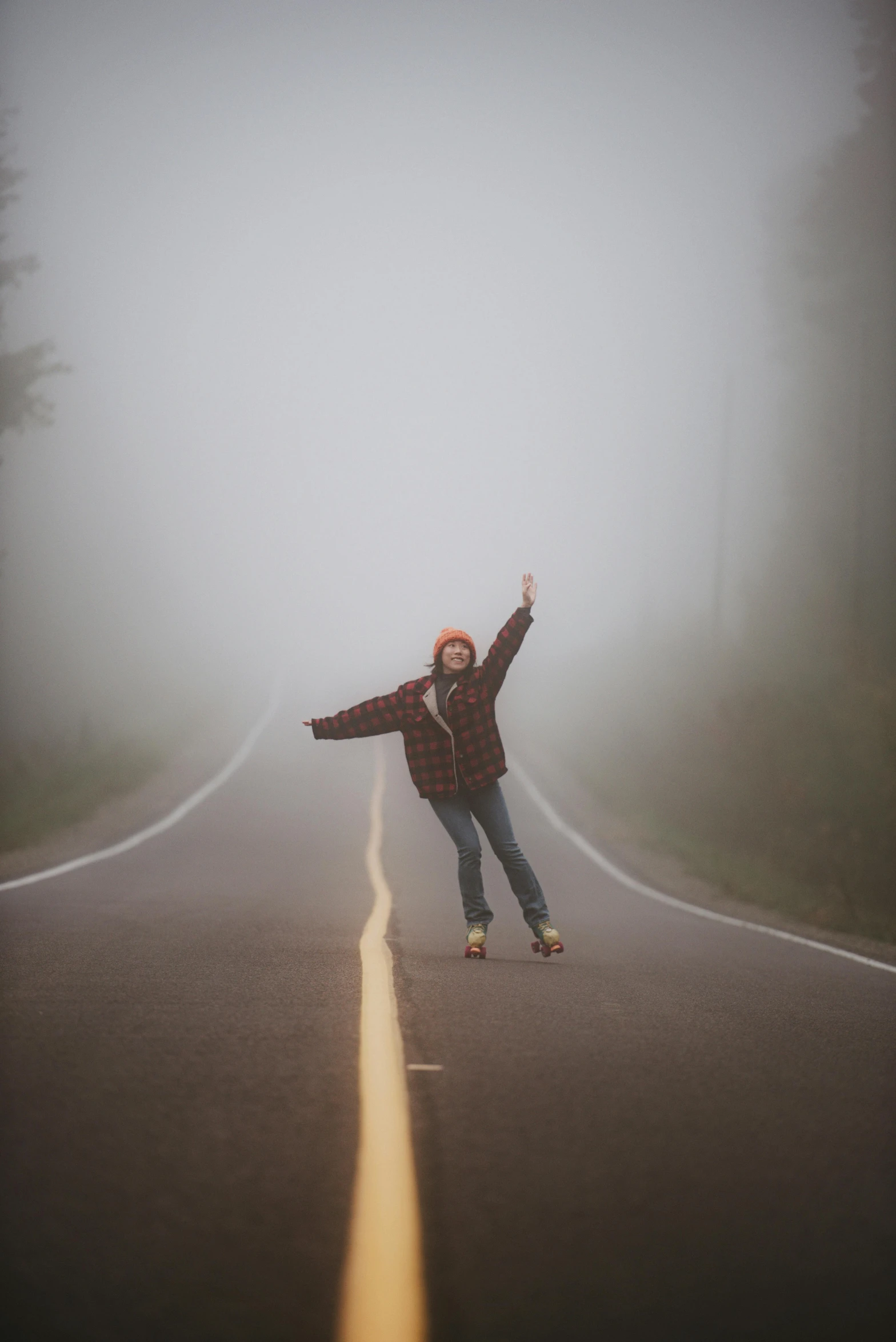 a person riding a skateboard on a foggy road, by Jessie Algie, pose(arms up + happy), twin peaks, misty ghost town, canvas