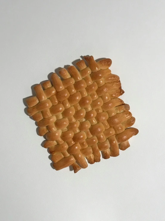 a close up of a piece of food on a table, lattice, light tan, detailed product image, loaves