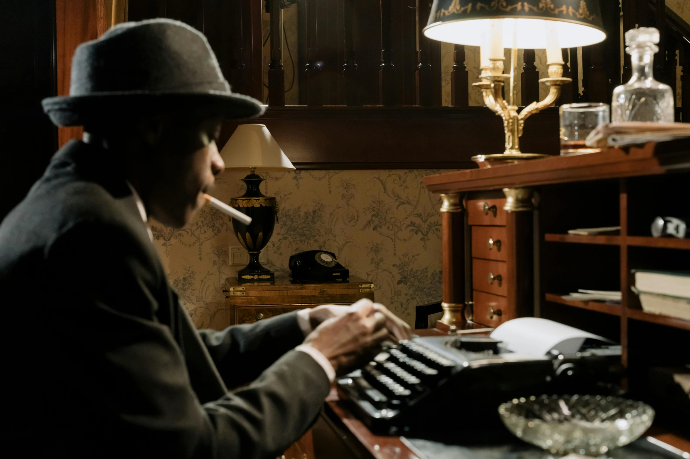 a man sitting at a desk typing on a typewriter, inspired by Sir William Orpen, harlem renaissance, costumes from peaky blinders, illuminating the area, an escape room in a small, shot with sony alpha