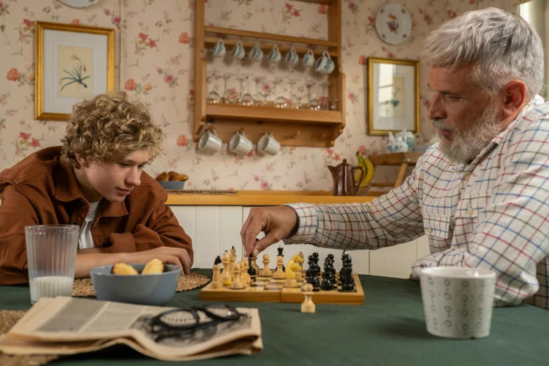 a man and a boy playing a game of chess, sophia lillis, father figure image, colour photo, thumbnail