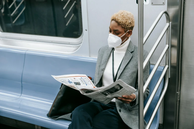 a woman sitting on a train reading a newspaper, trending on unsplash, medical mask, humans of new york style, ashteroth, gray men