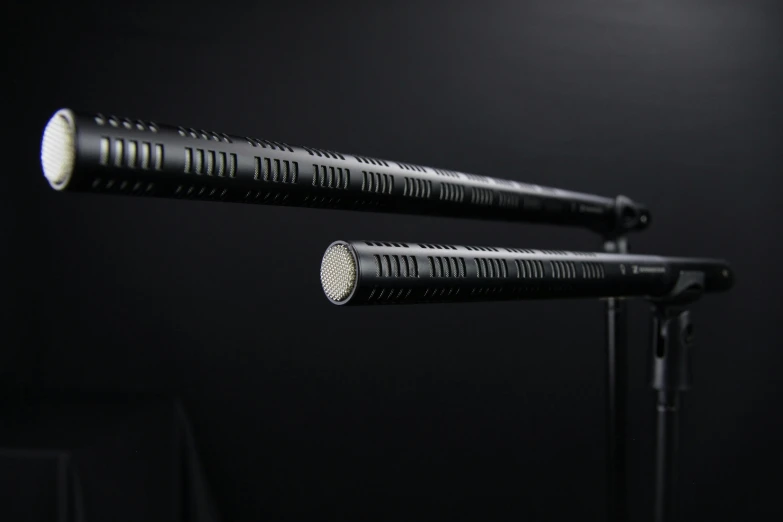 a pair of flashlights sitting on top of a table, cinematics lighting, swinging reflective katana, close up shot from the side, standing microphones