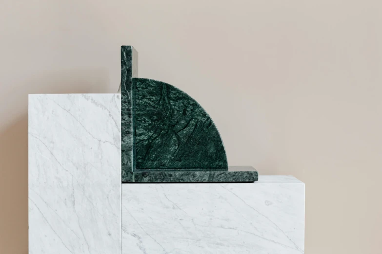 a marble bookend sitting on top of a marble block, by Emma Andijewska, dark green tones, wall corner, arcs, white marble