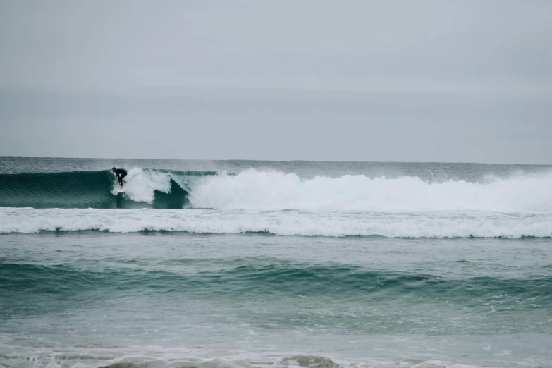 a man riding a wave on top of a surfboard, a photo, pexels contest winner, figuration libre, overcast day, seafoam green, cornwall, hd footage