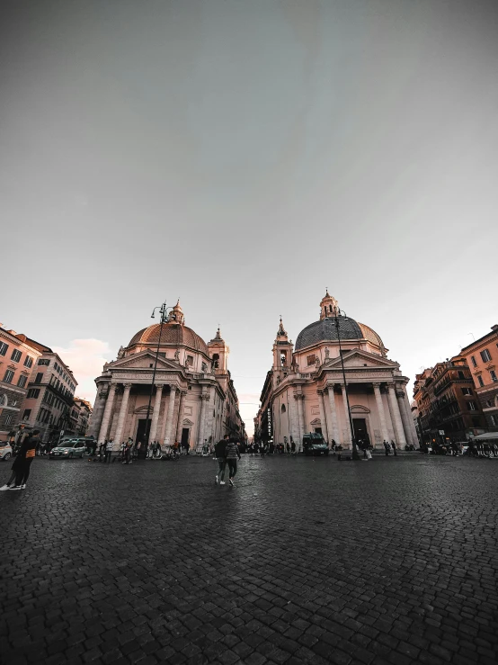 a black and white photo of some buildings, by Cagnaccio di San Pietro, pexels contest winner, renaissance, at dusk at golden hour, on a great neoclassical square, domes, promo image