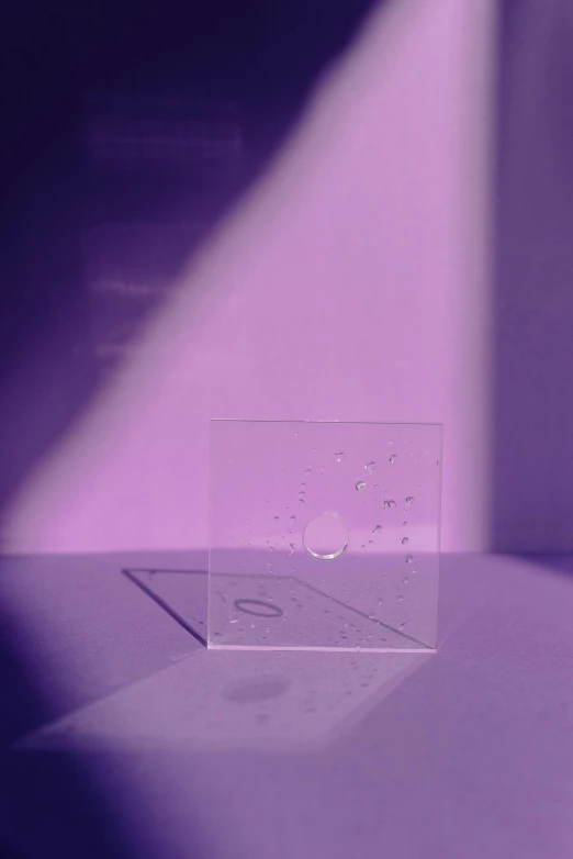 a clear box sitting on top of a table, an album cover, inspired by Lucio Fontana, unsplash, holography, purple drank, tumblr aesthetic, tiny points of light, profile pic