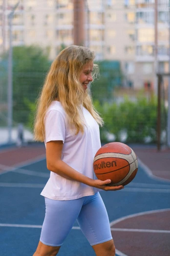 a woman standing on a basketball court holding a basketball, by Adam Marczyński, dribble contest winner, a girl with blonde hair, 15081959 21121991 01012000 4k