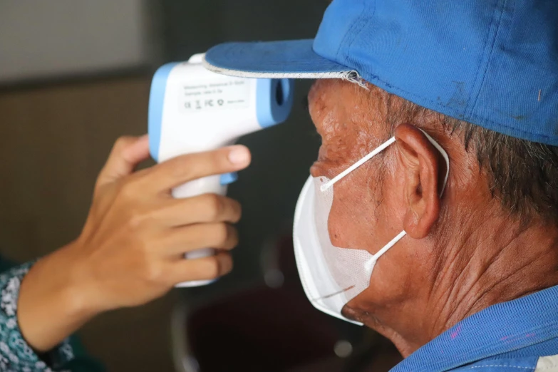 a close up of a person wearing a face mask, instrument, 3 meters, elderly, lerapi