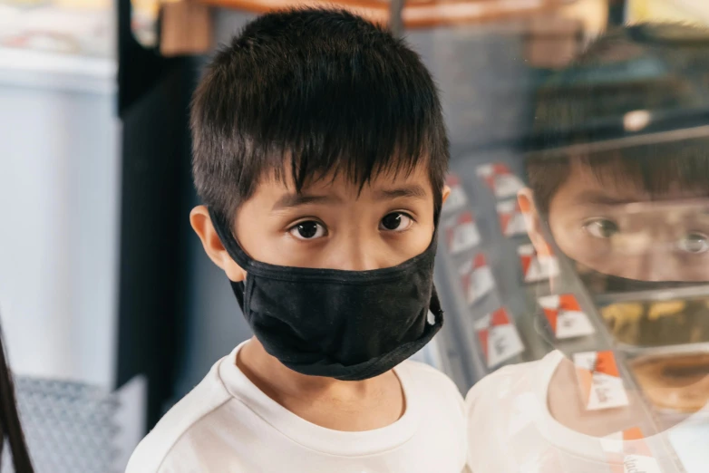 a young boy wearing a black face mask, inspired by Kanō Naizen, pexels contest winner, manuka, school class, essence, looking outside