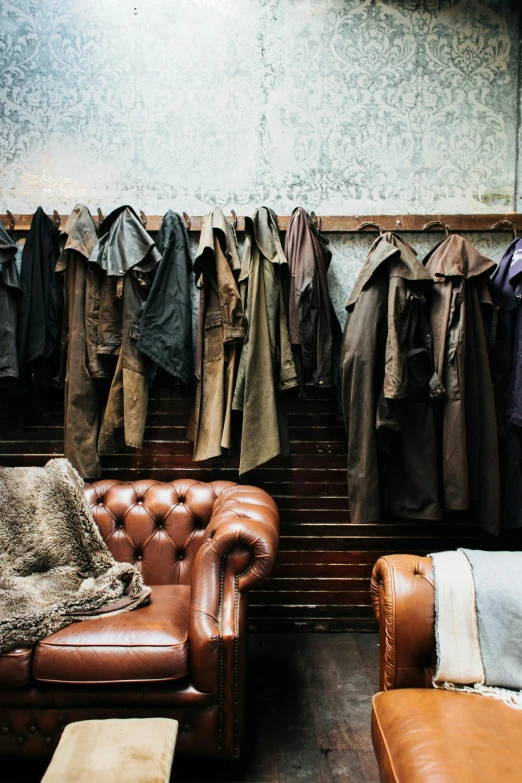a living room filled with furniture and lots of clothes, by Jan Tengnagel, trending on unsplash, baroque, leather duffle coat, leather hunting attire, thumbnail, conde nast traveler photo