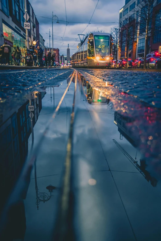 a puddle of water in the middle of a city street, by Micha Klein, unsplash contest winner, ireland, lines of lights, low detailed, landscape photo