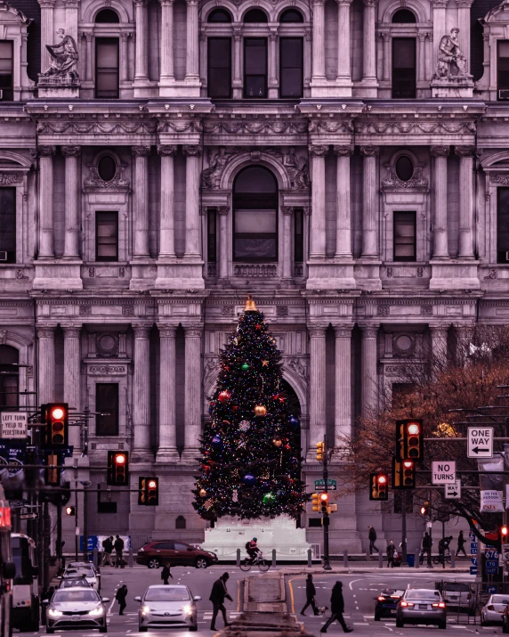 a large building with a christmas tree in front of it, by Jacob Burck, unsplash contest winner, baroque, new jersey, gritty!!!, purple hues, monumental structures