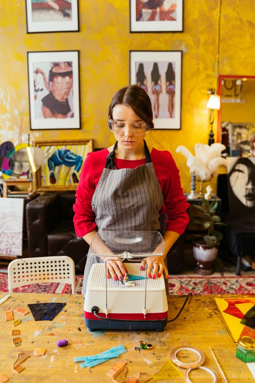 a woman in an apron working on a sewing machine, an album cover, pexels contest winner, in the style wes anderson, maia sandu hyperrealistic, at home, impasto