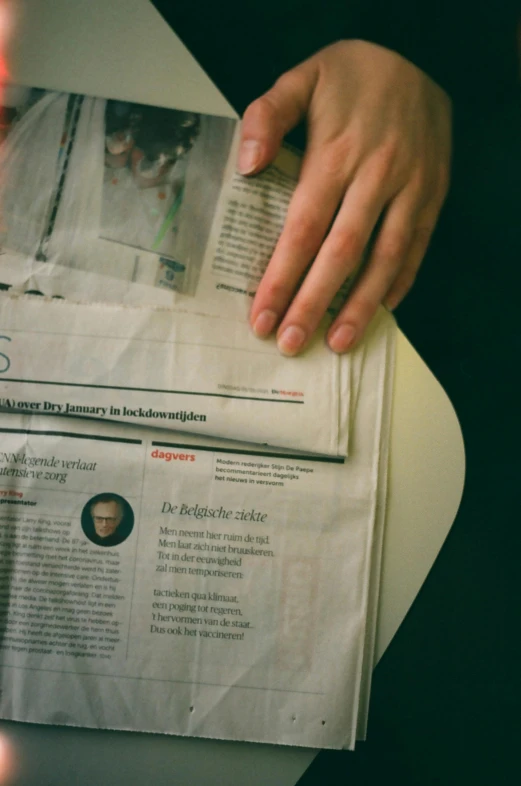 a close up of a person reading a newspaper, by Sebastian Spreng, center of image, instagram story, taken in the late 2010s, johanna rupprecht