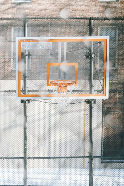 a basketball hoop in front of a brick building, looking down on the camera, translucent, no - text no - logo, orange grey white