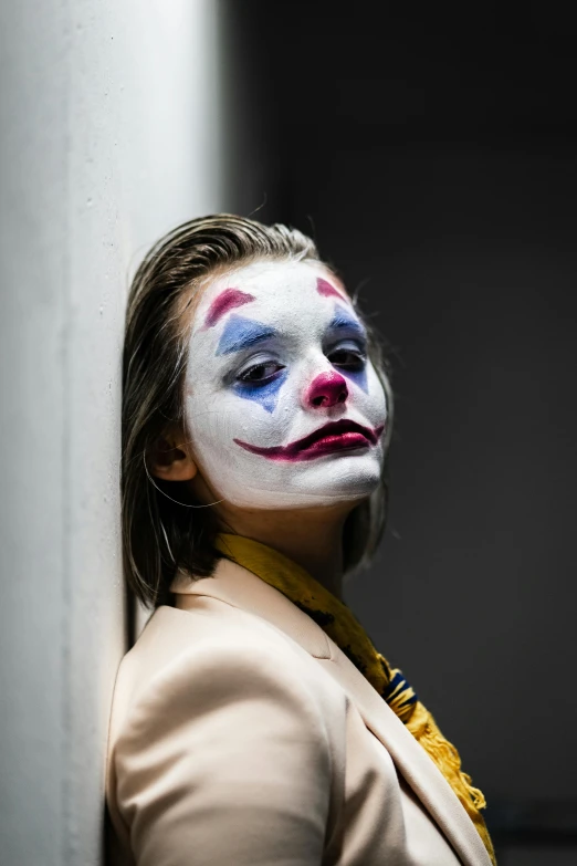 a woman with a clown face painted on her face, trending on pexels, film still of batman, girl in suit, ( ( theatrical ) ), colored