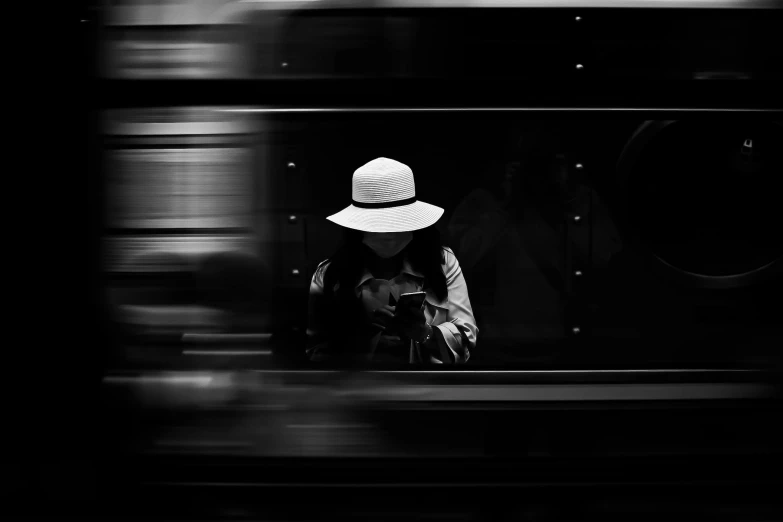 a black and white photo of a person wearing a hat, a black and white photo, by Emma Andijewska, unsplash contest winner, train, smartphone photo, bangkok, digital art #oneshotgame