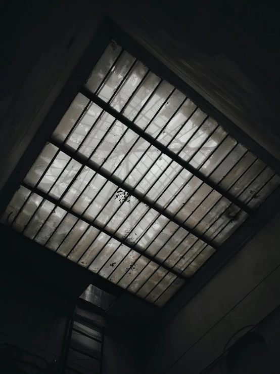 a skylight in a dark room with a ladder, inspired by Elsa Bleda, unsplash, ceiling, low quality photo, dark and grungy, instagram story