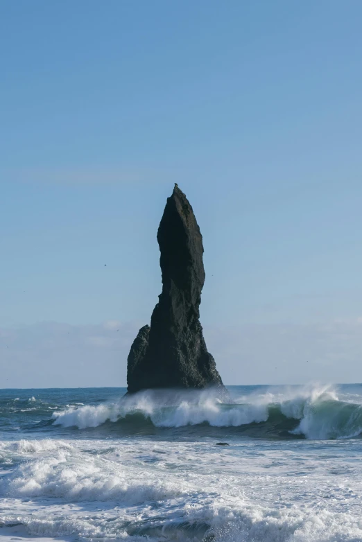 a large rock sticking out of the ocean, by Daarken, asymmetrical spires, 1km tall, towering waves, on display