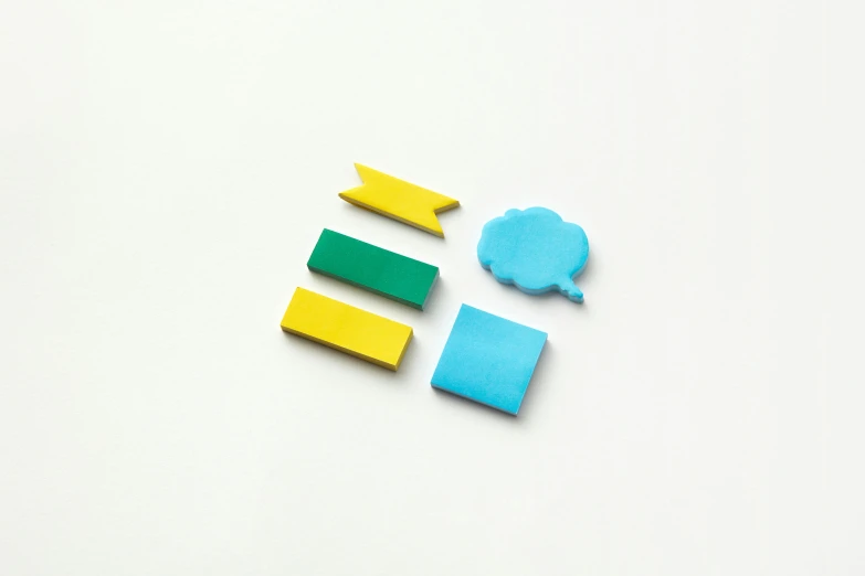 a group of colorful magnets sitting on top of a white surface, blue theme and yellow accents, no speech bubbles, high quality product image”, kousuke oono
