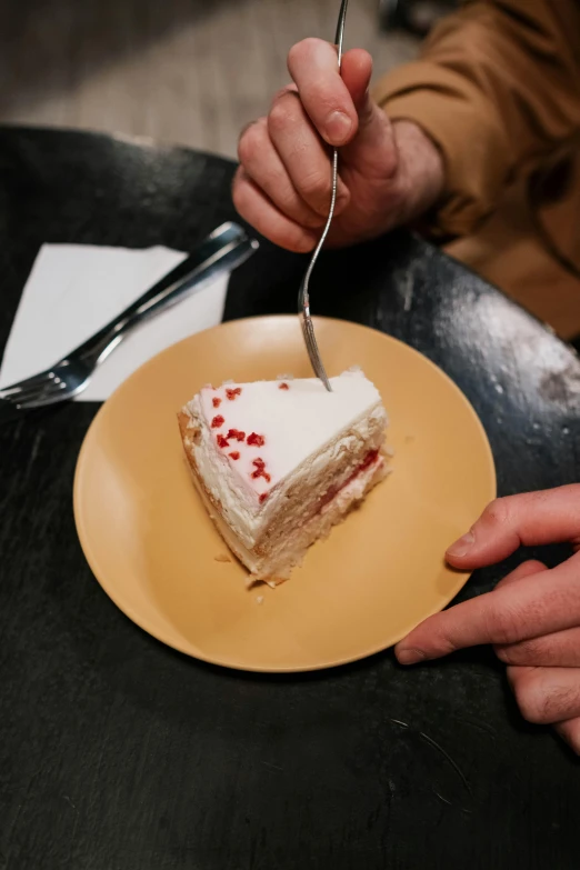 a person eating a piece of cake with a fork, slightly red, frank moth, melbourne, cream