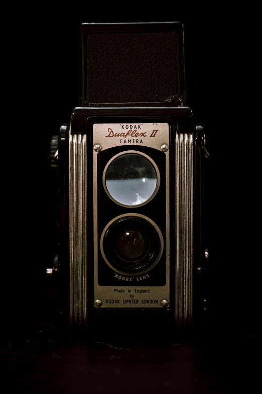 an old camera sitting on top of a table, inspired by Diane Arbus, photorealism, on black background, deluxe, f / 2 0, detailed - i
