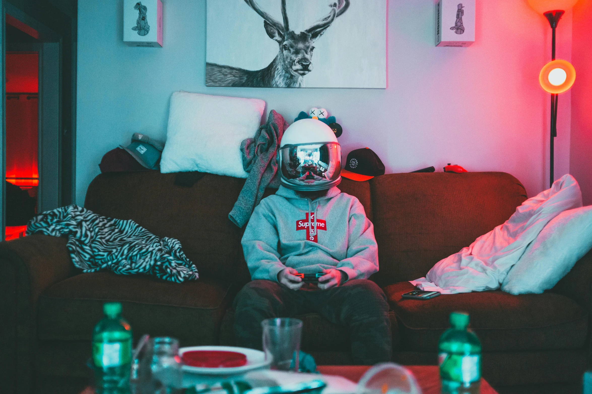 a person sitting on a couch wearing a helmet, pexels contest winner, maximalism, gamer, lonely astronaut, friday night funkin, younger brother vibes