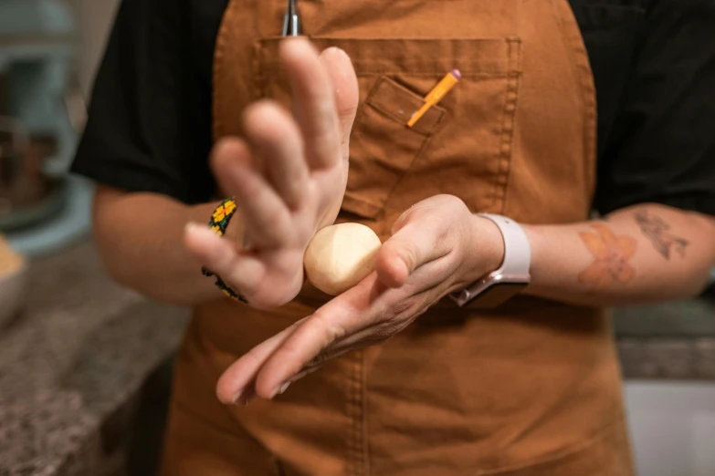 a close up of a person holding an egg, inspired by Sarah Lucas, process art, weta workshop, partially cupping her hands, woodturning, lachlan bailey