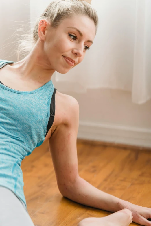 a woman laying on the floor using a laptop, by Julian Allen, sport bra and shirt, lynn skordal, zoomed in, showing her shoulder from back