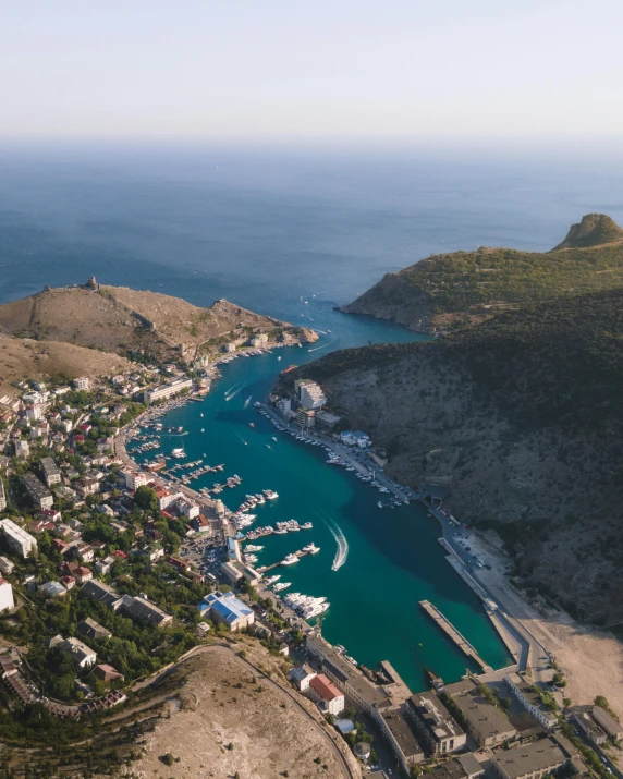 a large body of water next to a lush green hillside, pexels contest winner, magical soviet town, harbor, gif, square