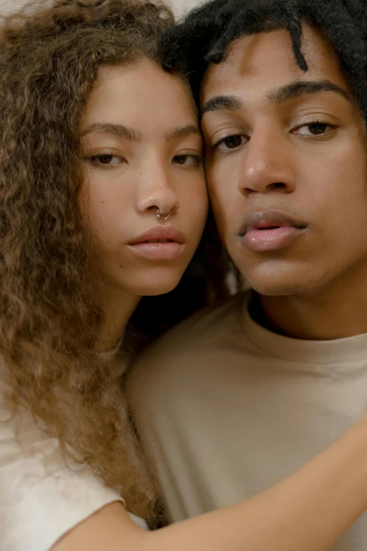 a man and a woman posing for a picture, by Cosmo Alexander, trending on pexels, renaissance, soft freckles, black teenage boy, lesbian embrace, neutral focused gaze